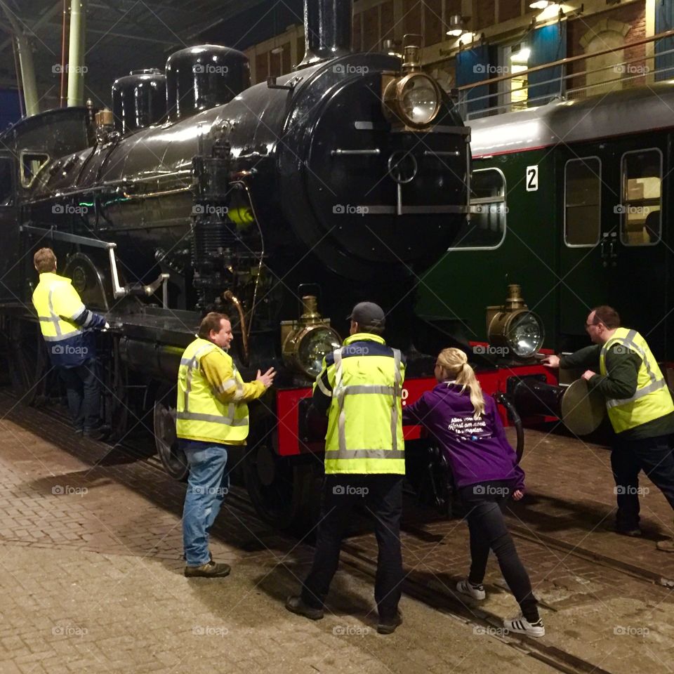 Group of workers with train engine