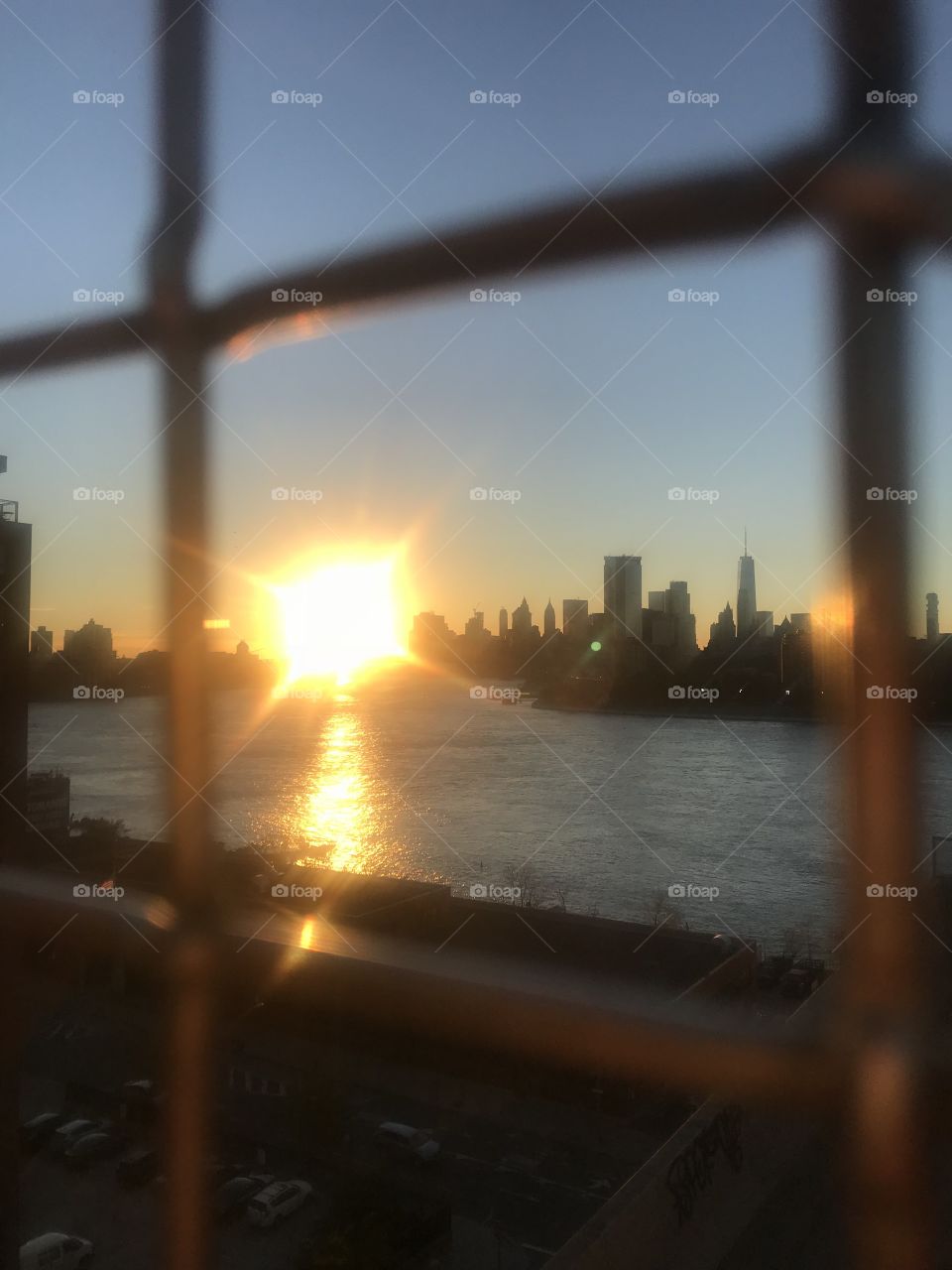 NYC skyline through chain link 