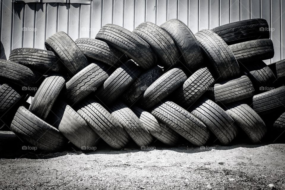 Background photo of used tires stacked on top of one another in closeup