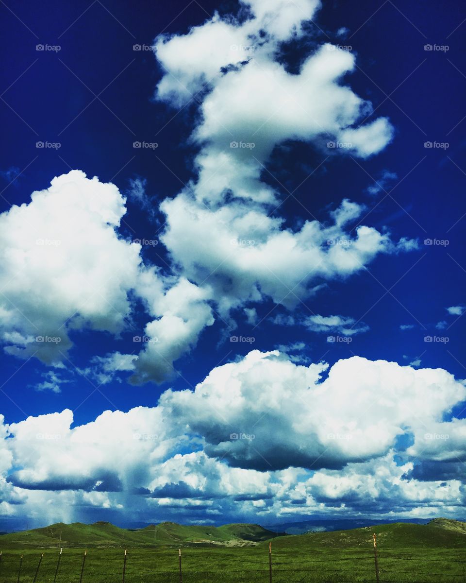 Clouds sky pasture foothills country green blue white open range wide open