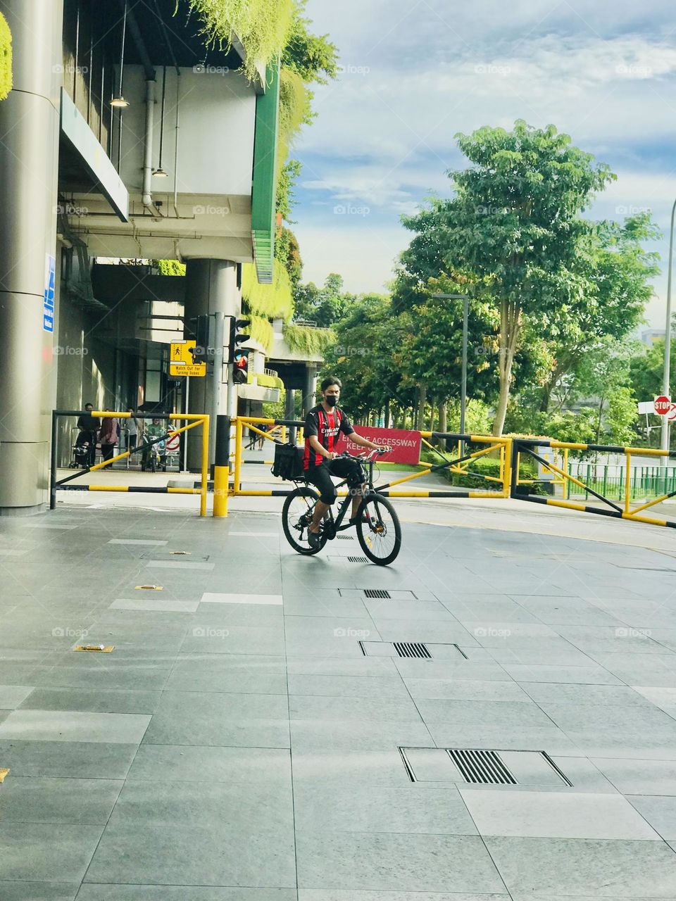 A person going in his way on a bicycle near the shopping mall 