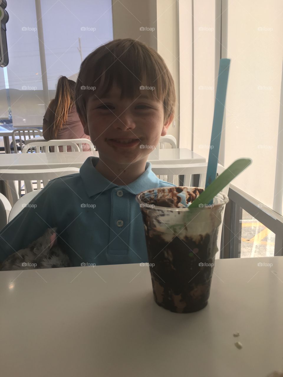 Happy young boy eating ice cream