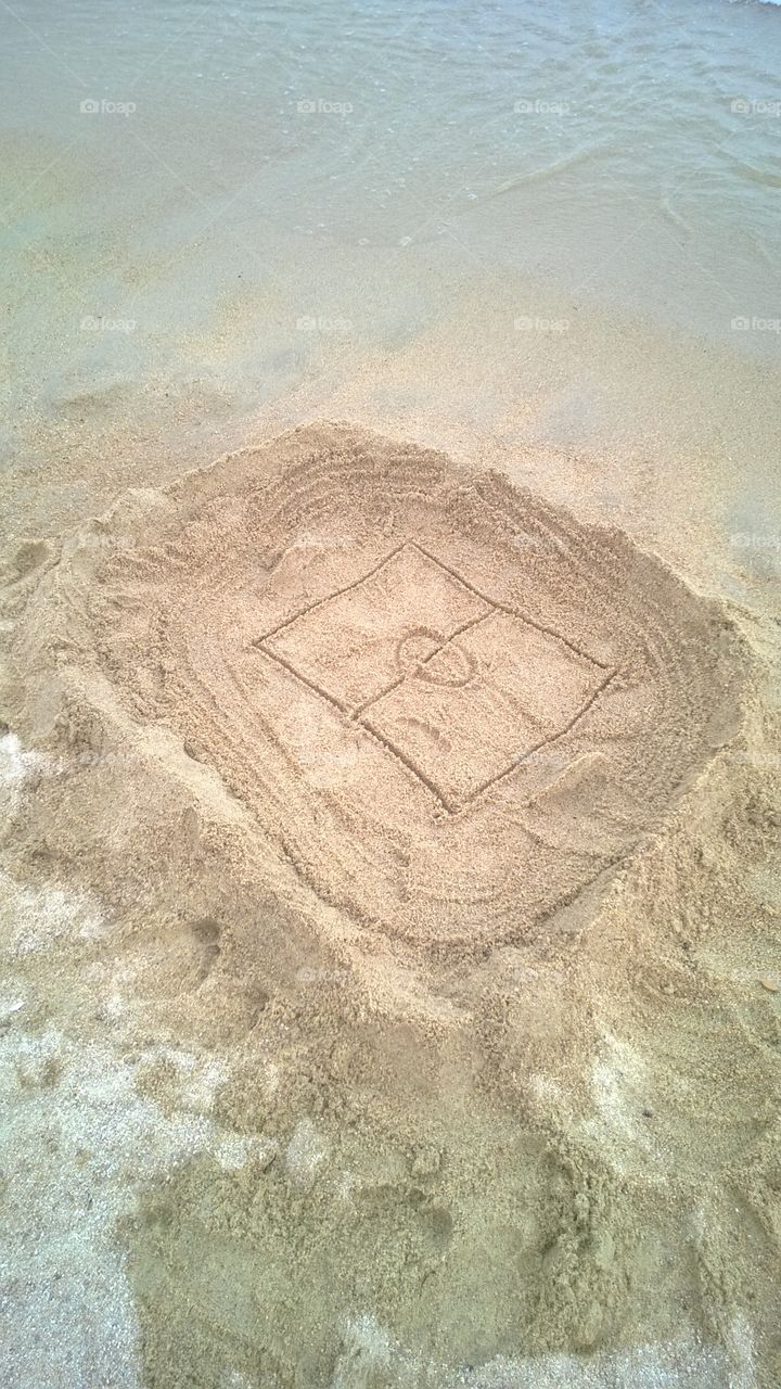 Sand stadium on the beach. Kids made stadium of sand for baseball