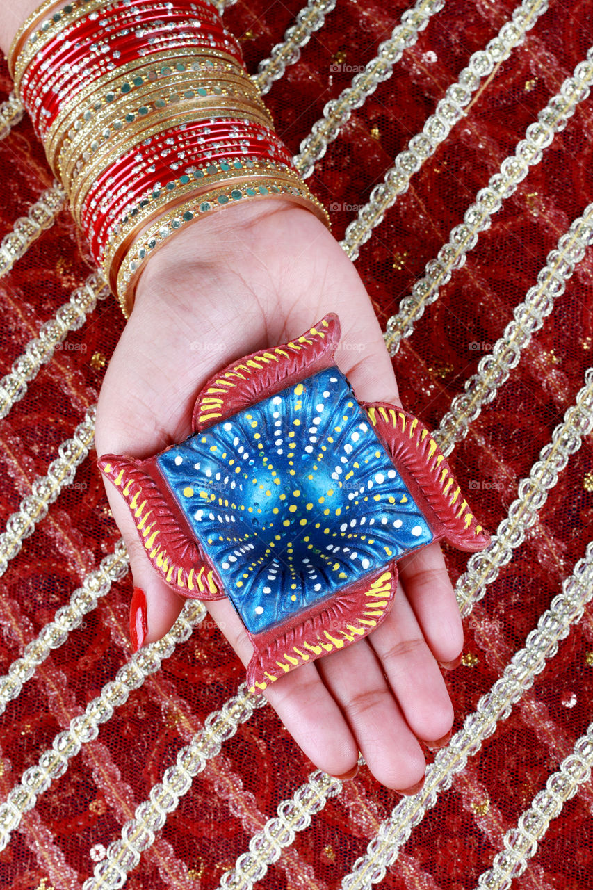 Diwali diya in a hand