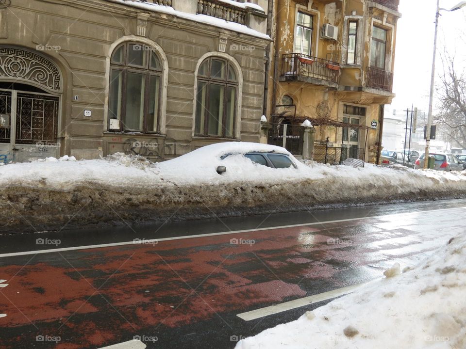 Car stuck in thick layer of snow