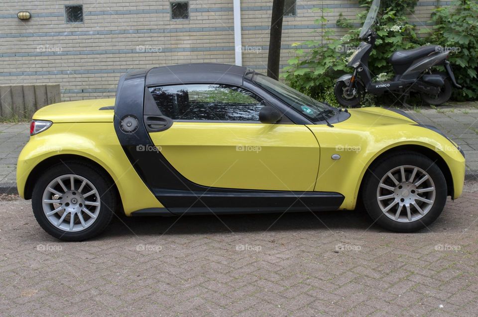A Yellow Smart Car At Amsterdam The Netherlands 20-5-2024