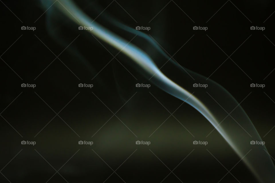 Smoke scented candles on a black background