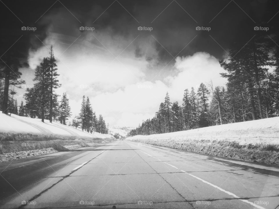 cloudy sky and clean road with snowy road side
