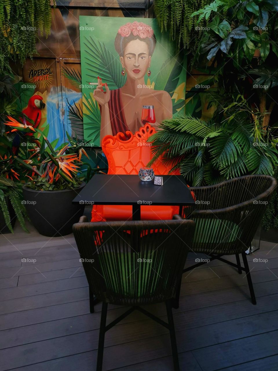 Beautiful interior with colourful paintings and green plants. Portrait of Frida Kahlo. Amazing atmosphere. Nice place in Vilnius. Spritz Summer Garden.