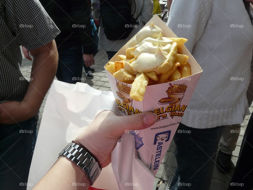 French fries with mayonnaise in a cardboard container on a street in Brussels Belgium 