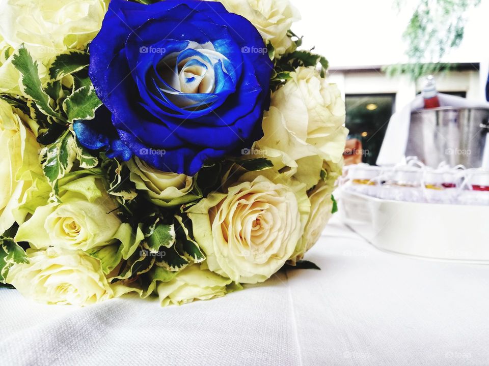 bridal bouquet with white roses and a blue rose