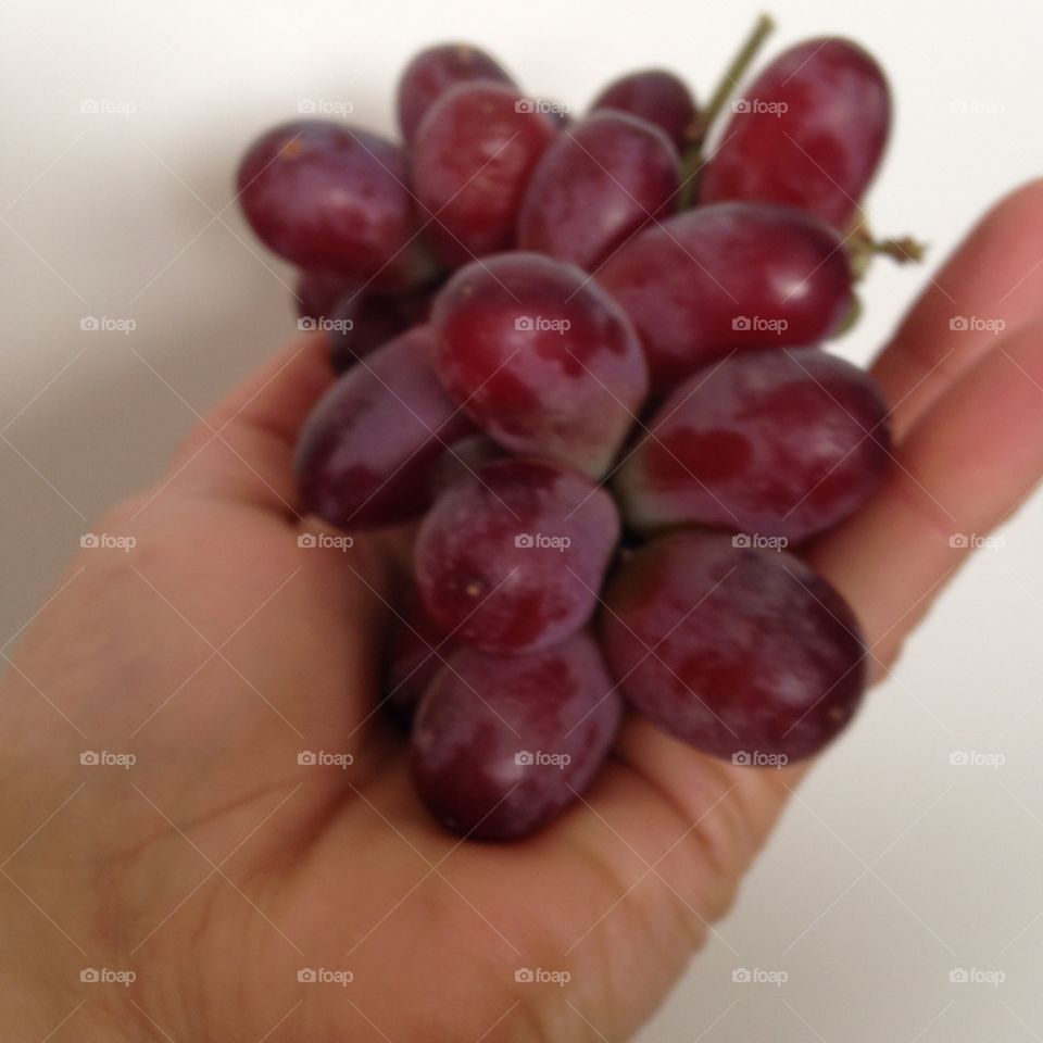 Holding red grapes 