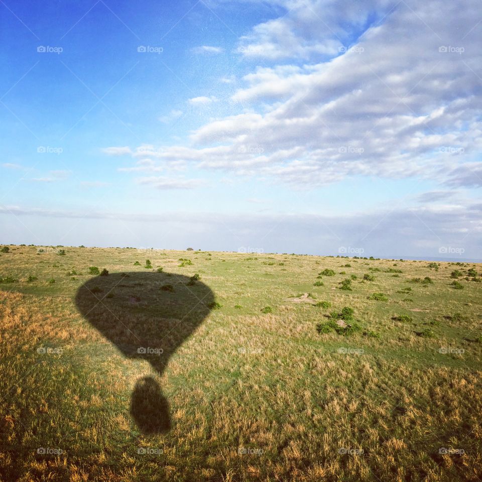 Shadow of hot air ballon over the vast Savanna 