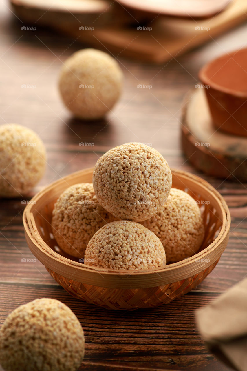 Indian sweet laddoo in a handmade wooden bowl