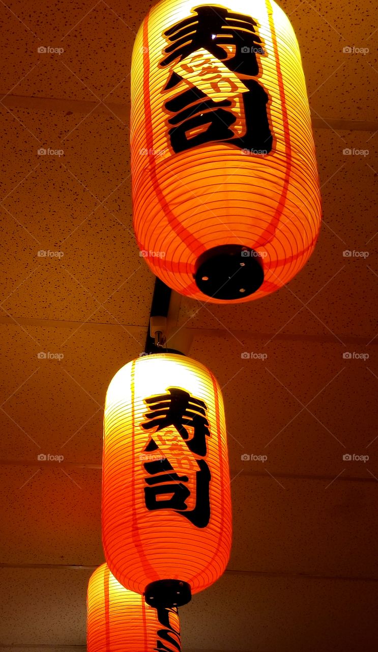 Asian paper lantern light fixtures at a neighborhood restaurant. They give off a lovely orange glow.