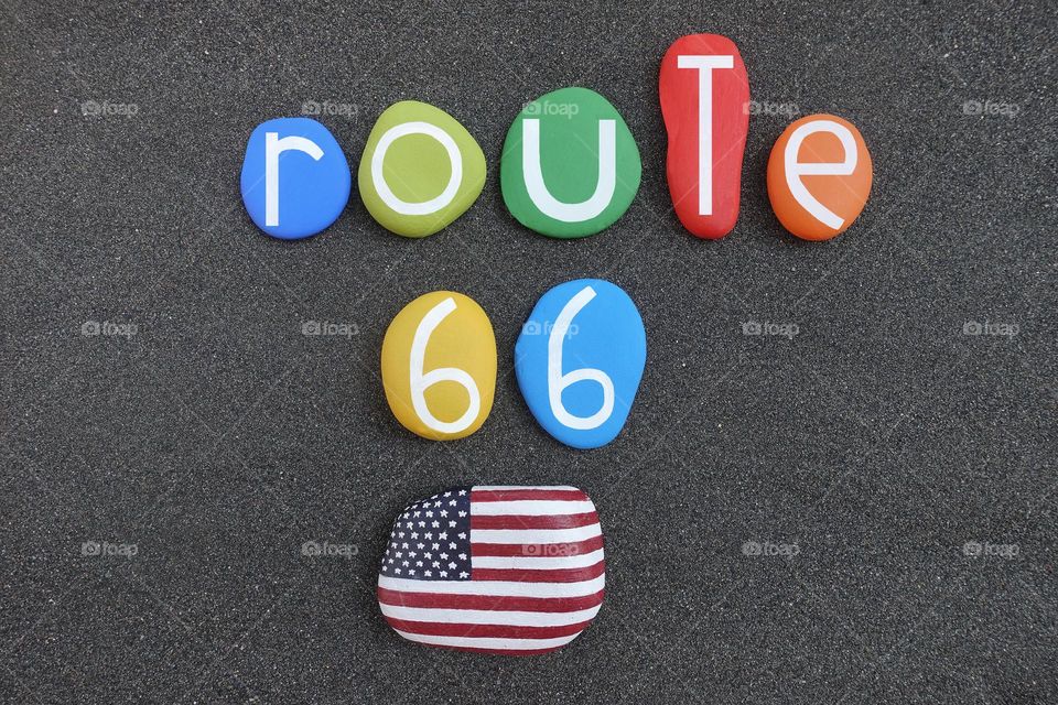 United States of America, Route 66, creative logo composed with multi colored stone letters over black volcanic sand and USA stone design