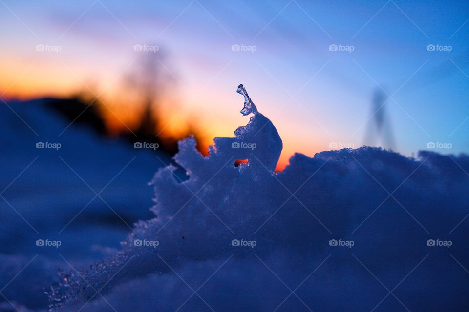 photo of a melting snowdrift at sunset. This photo, despite the coldness, belongs to spring.