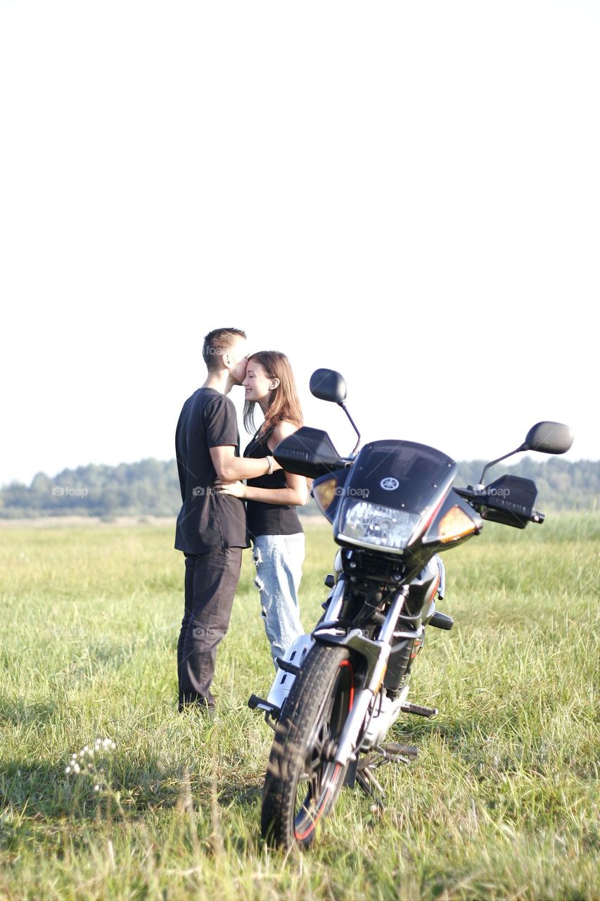 portrait of lovers near a motorcycle