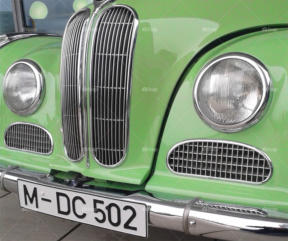 A green old style car.