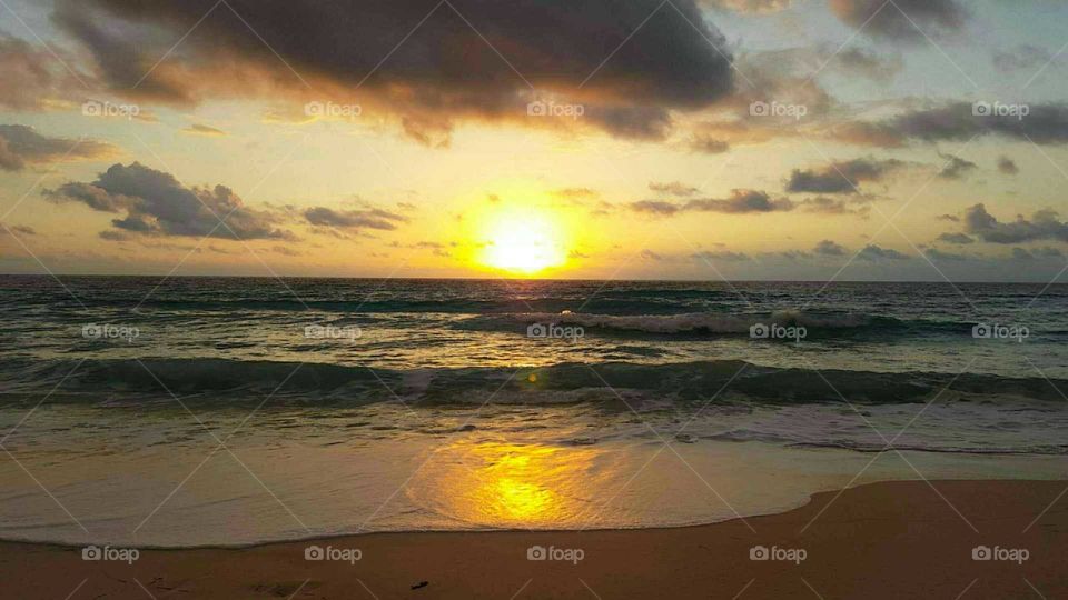 the sun over the ocean in Mexico