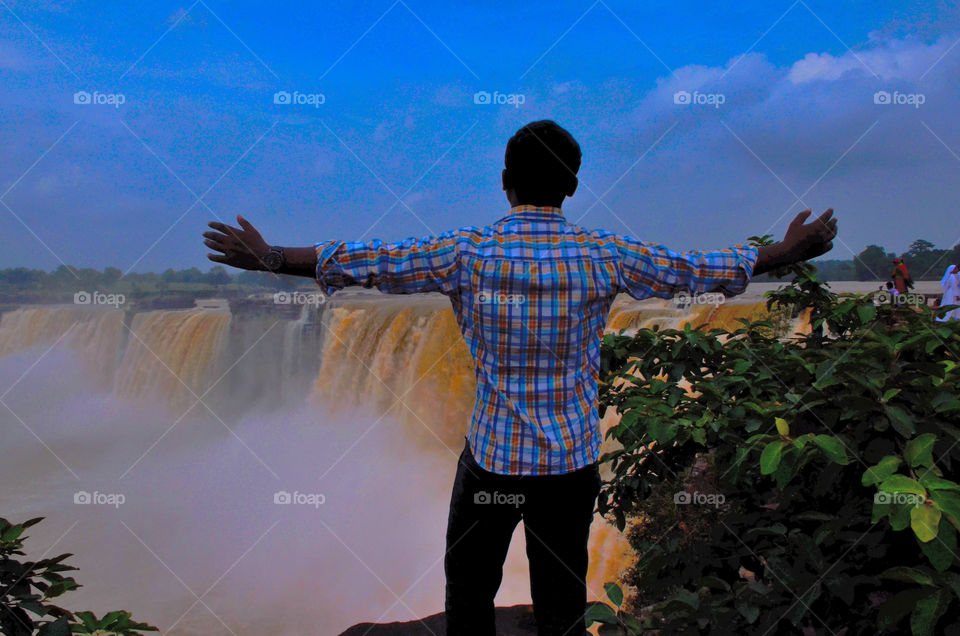 boy enjoying waterfall