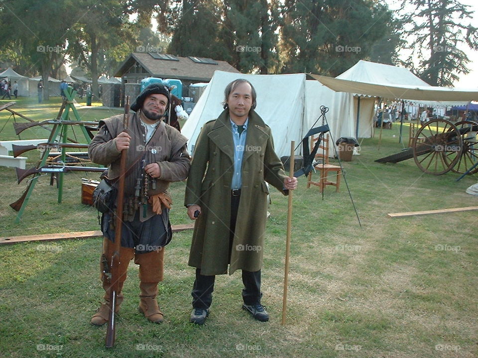 Two armed yet happy individuals at the Renaissance Faire. They are both the martially adventurous types ready for excitement and action.