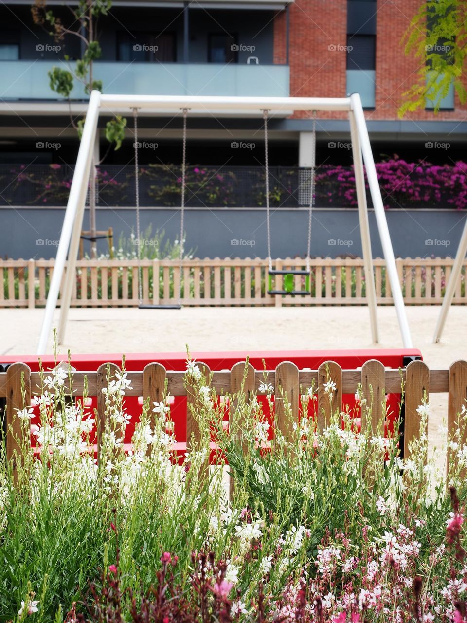The flowers and the swings in a playground