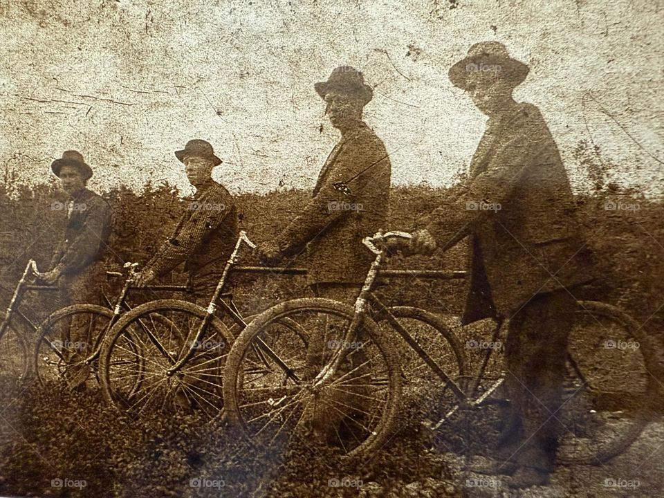 Four men with bycicles