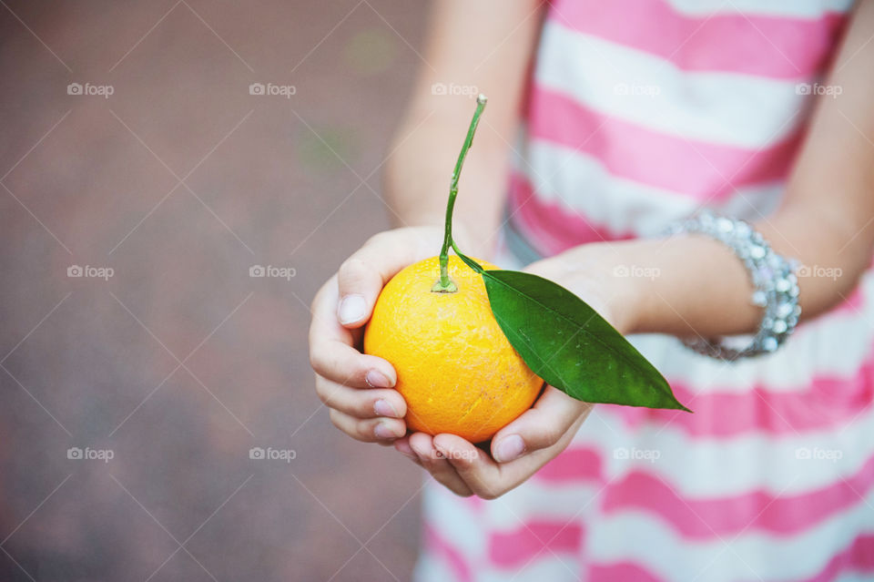Holding an orange 