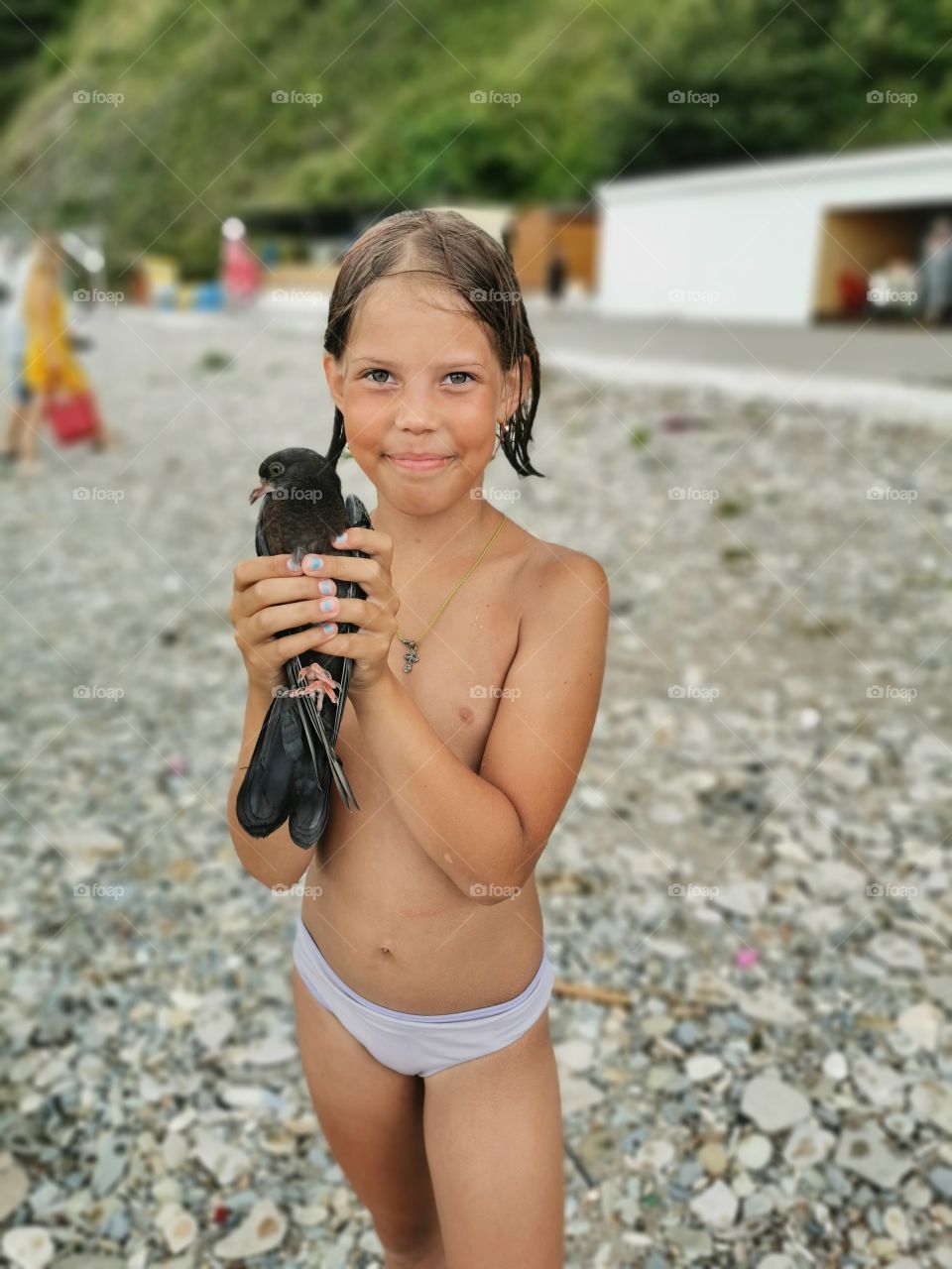 Satisfied child with a bird in his hands