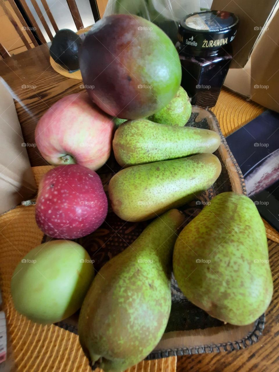 pears and apples on a tray on kitchen table