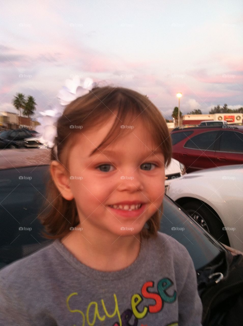flower in her hair. picked up a flower headband while shopping and she had to have a pic of herself wearing it