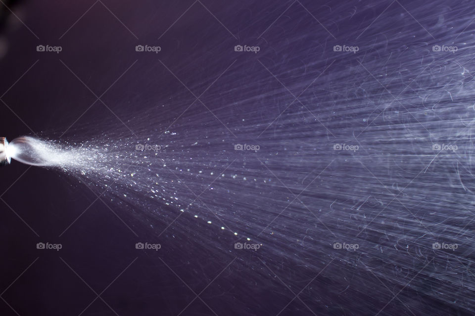 Spraying water dark background 