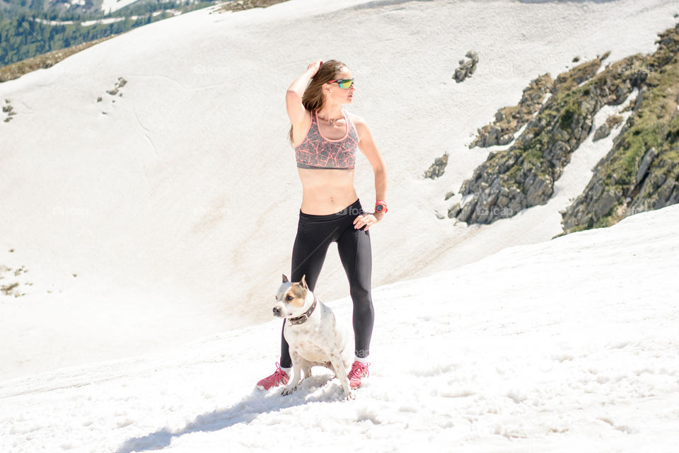 woman with a dog in the snow in summer