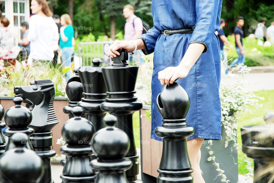 Girl playing in the outdoor large chess