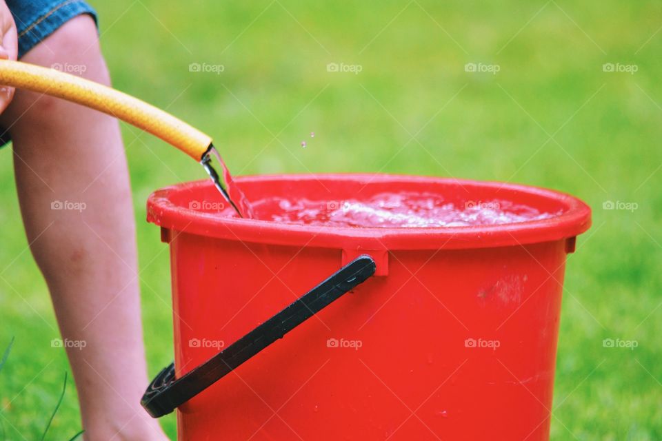 Filling a bucket with water 