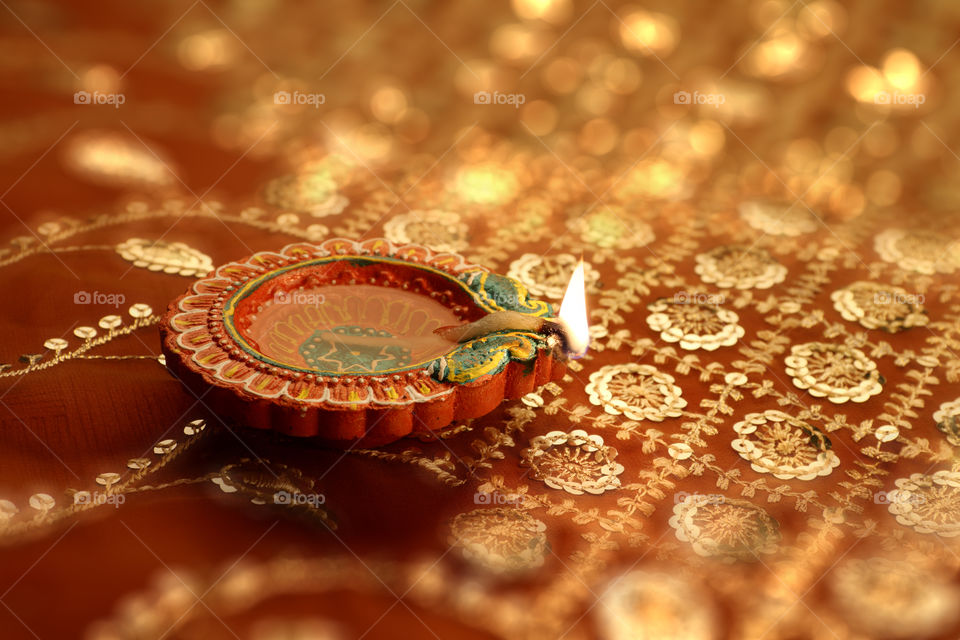 Diwali diya oil lamp on beautiful bokeh in background
