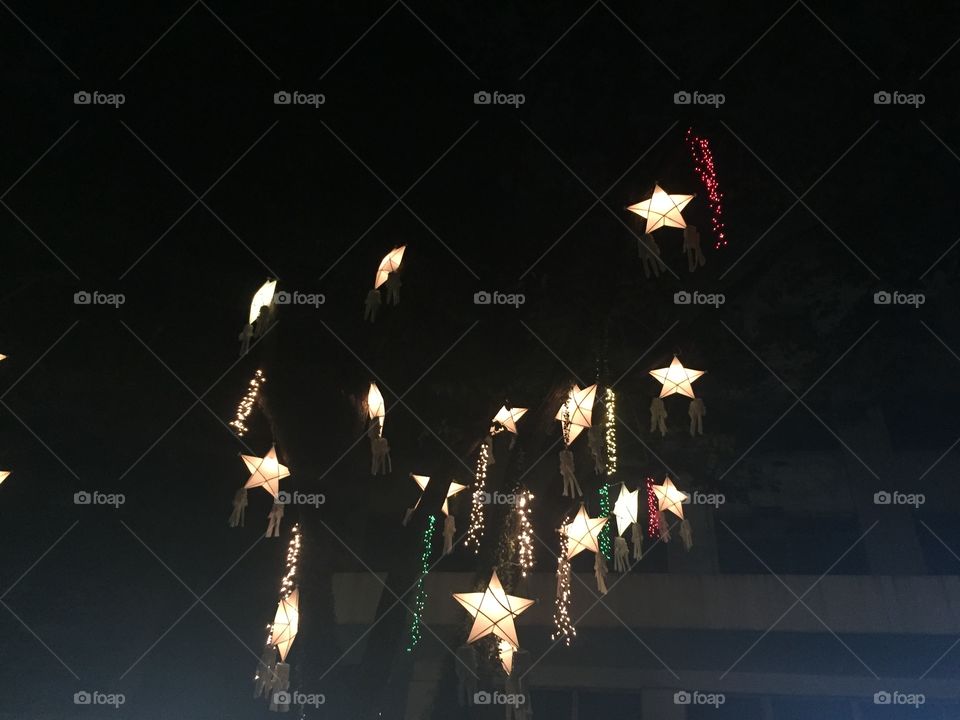 Night Christmas lights in the Philippines. Traditional patrol  stars lighting up my school