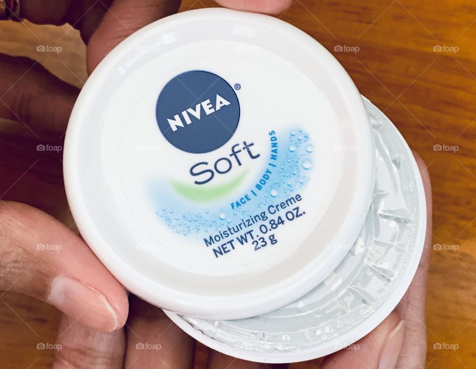 Opening the Nivea soft moisturizing creme