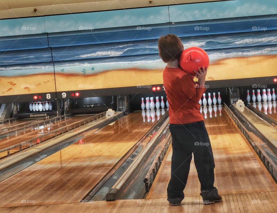 Boy At A Bowling Alley. American Indoor Sport
