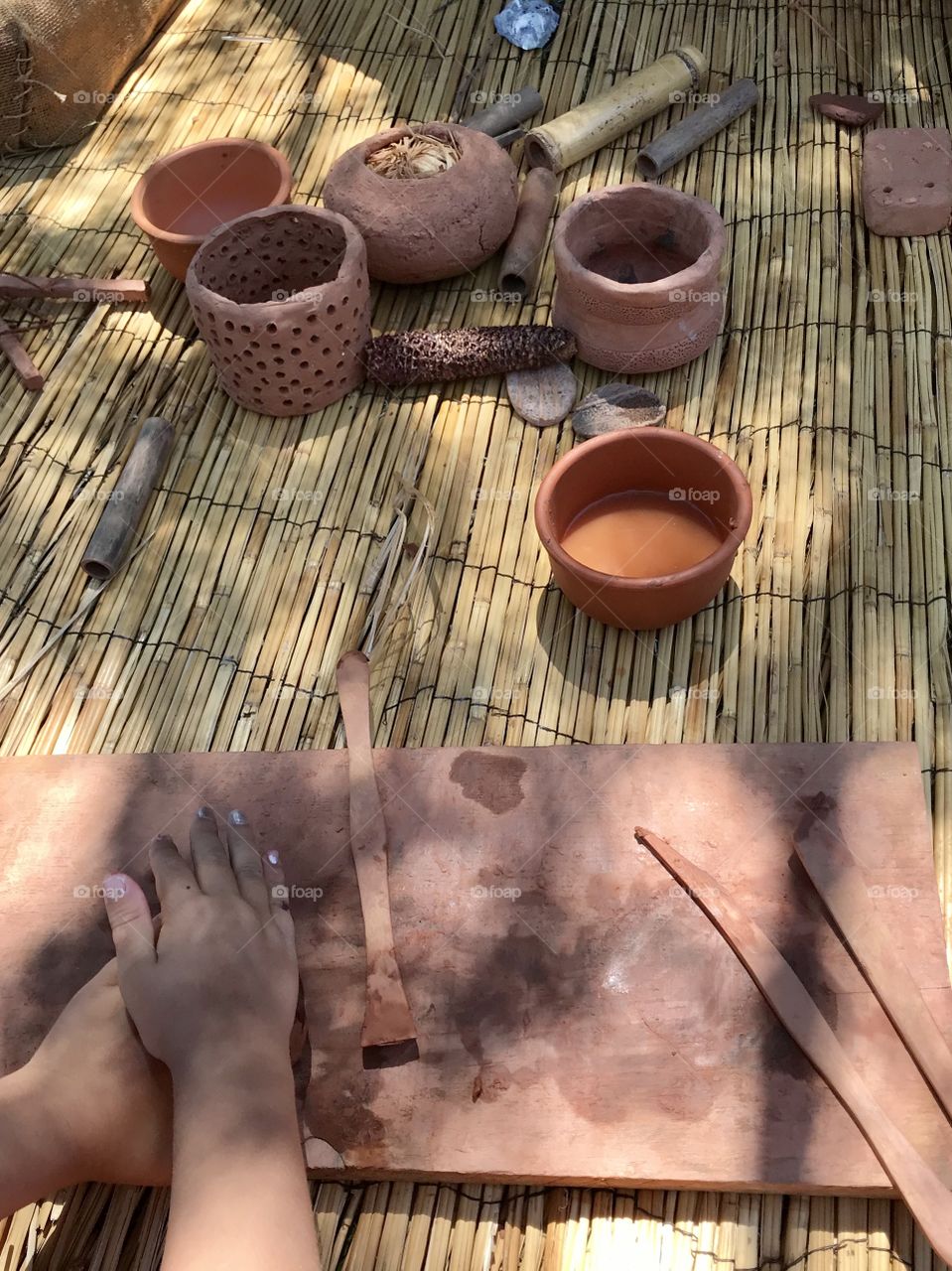 Playing with clay outdoors and making pottery 