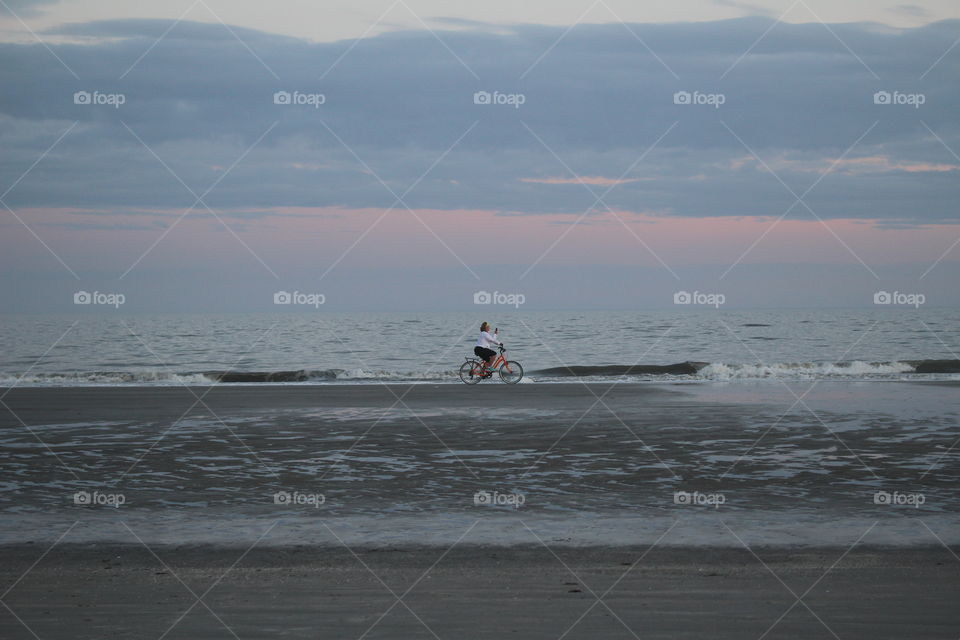 woman riding a bicycle on the beach