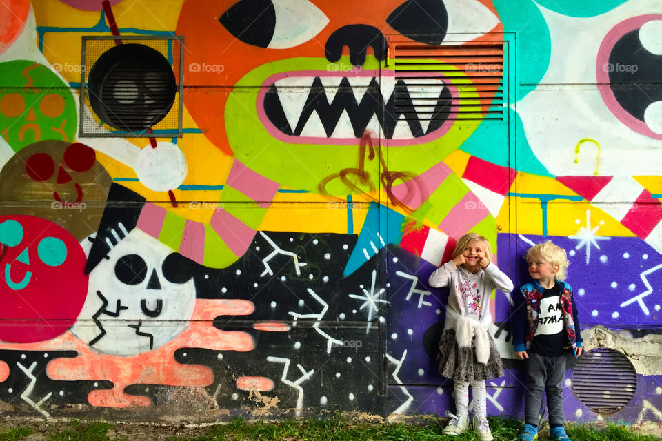 Kids in front of a graffiti wall