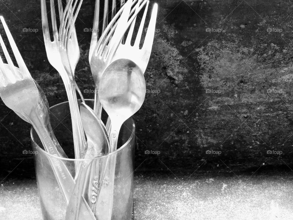 Spoons and forks in a glass