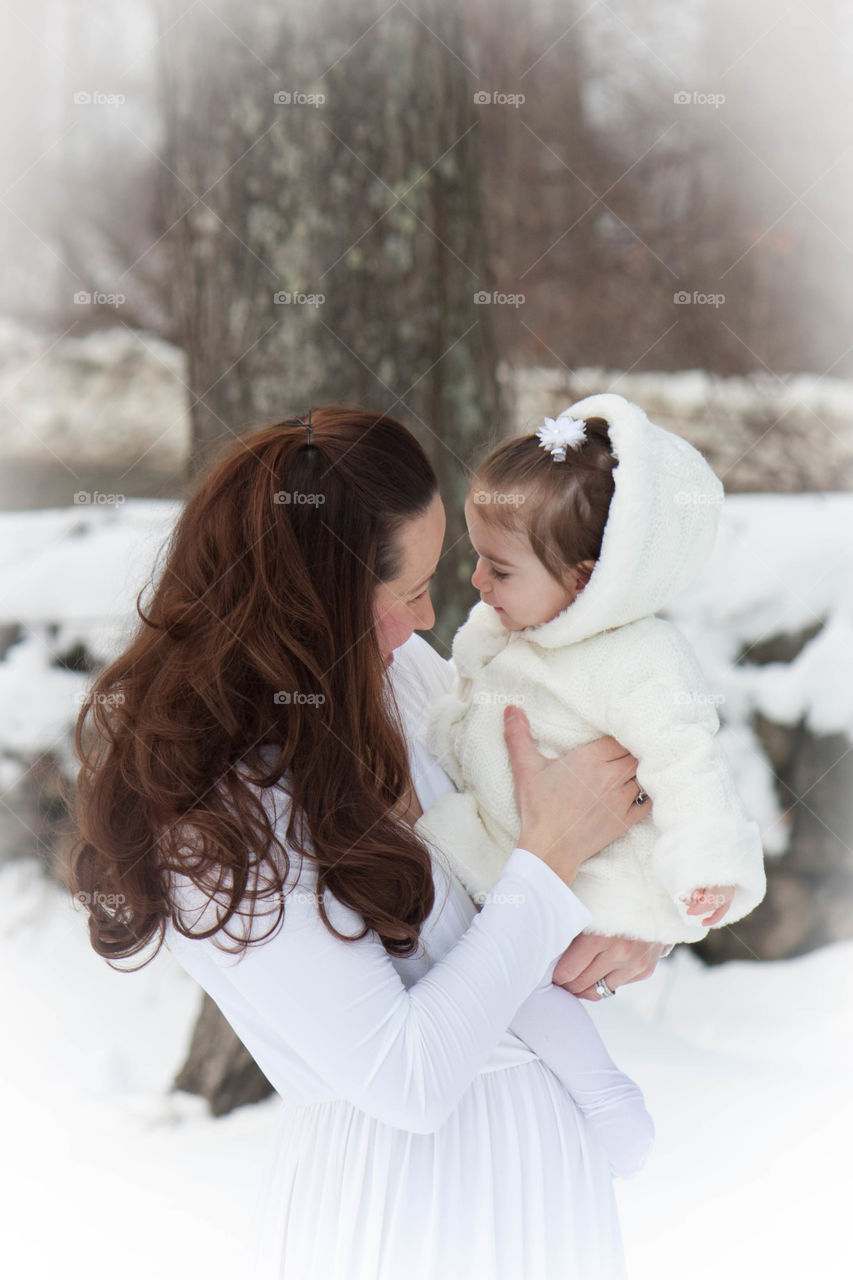 Mother with her daughter in winter