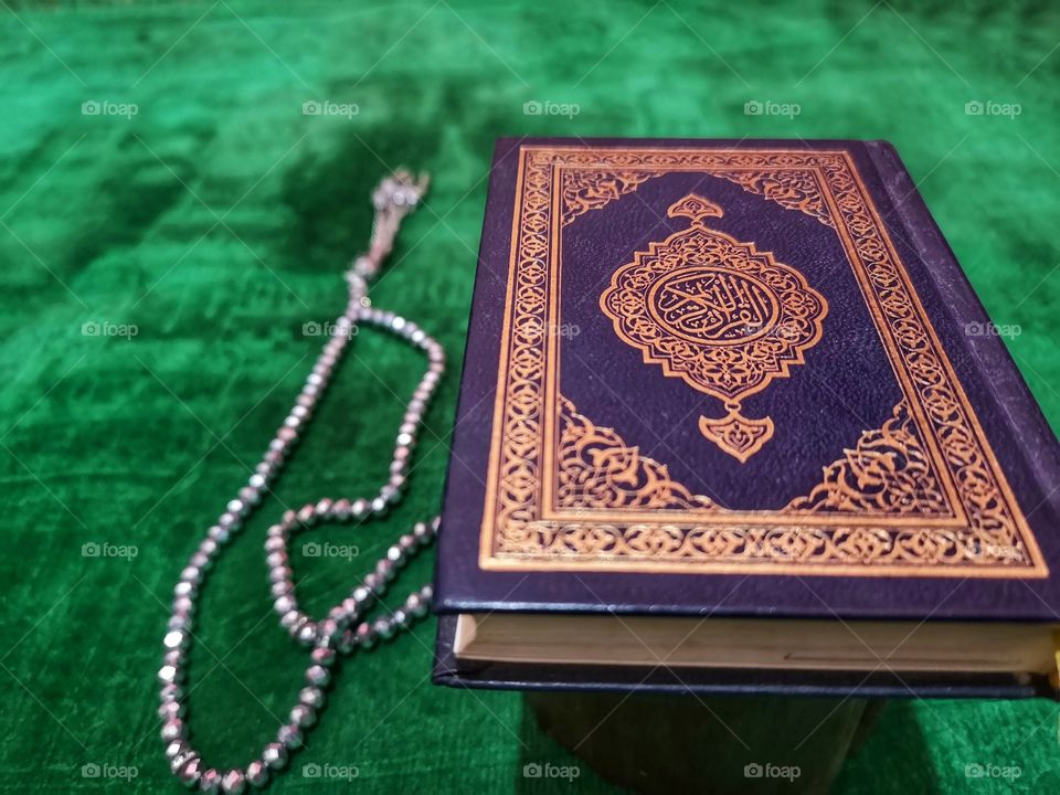 Al-quran on praying mat with rosary bead. Islamic and muslim concept