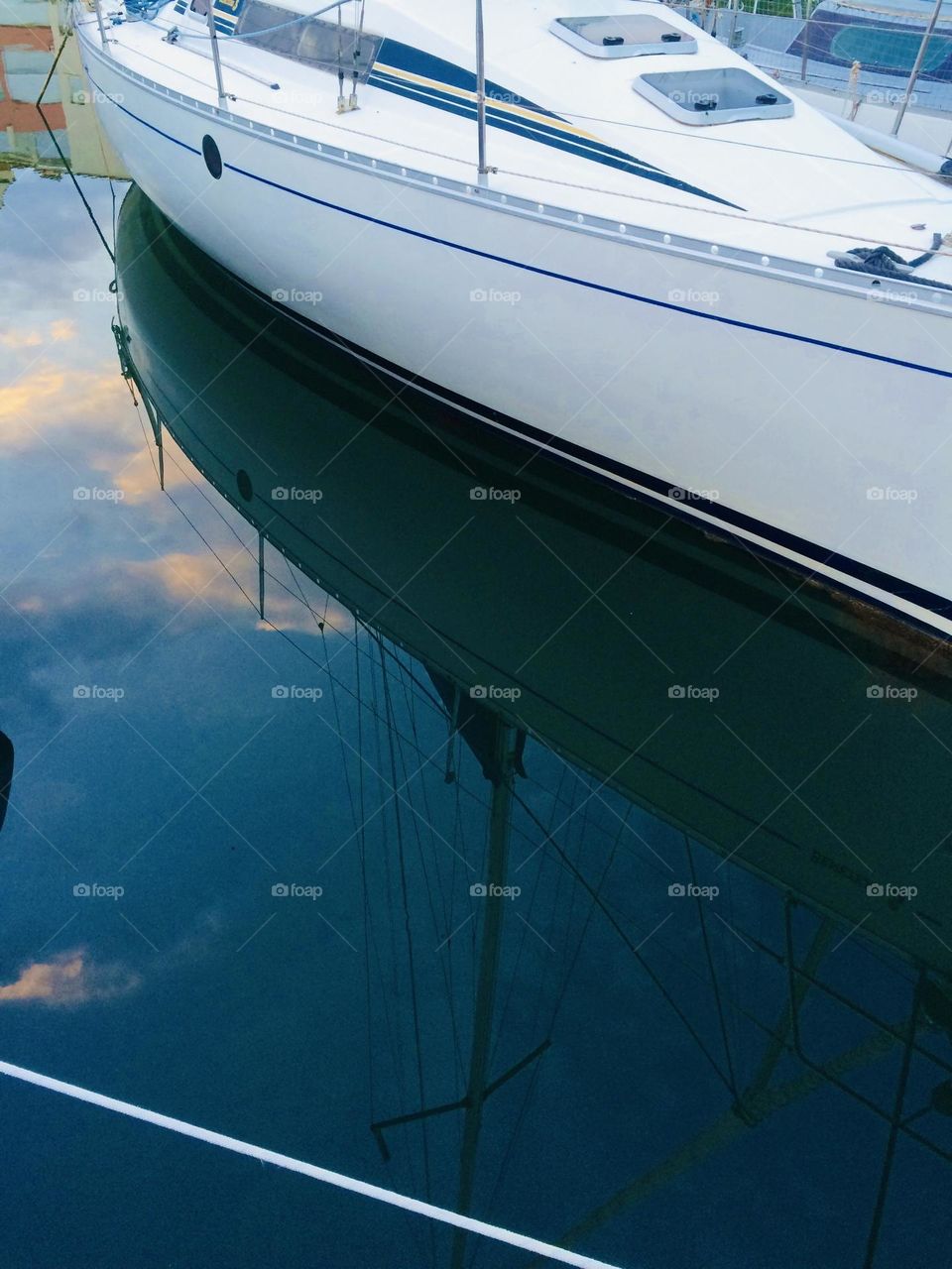 Boat reflection in the water at sunset 