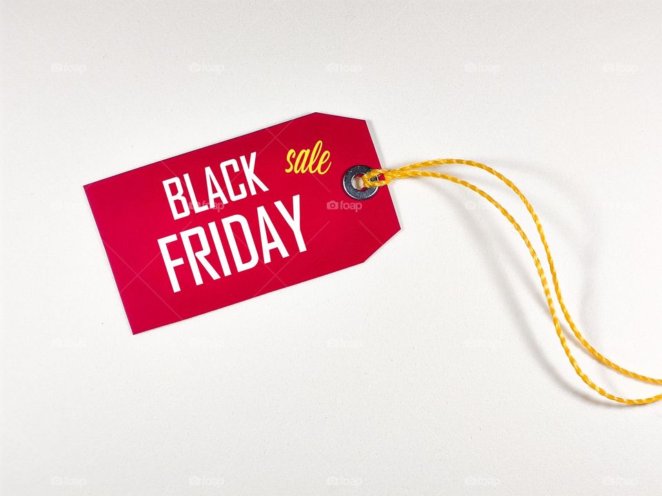 a red paper label with the text black friday sale written in it against a white background