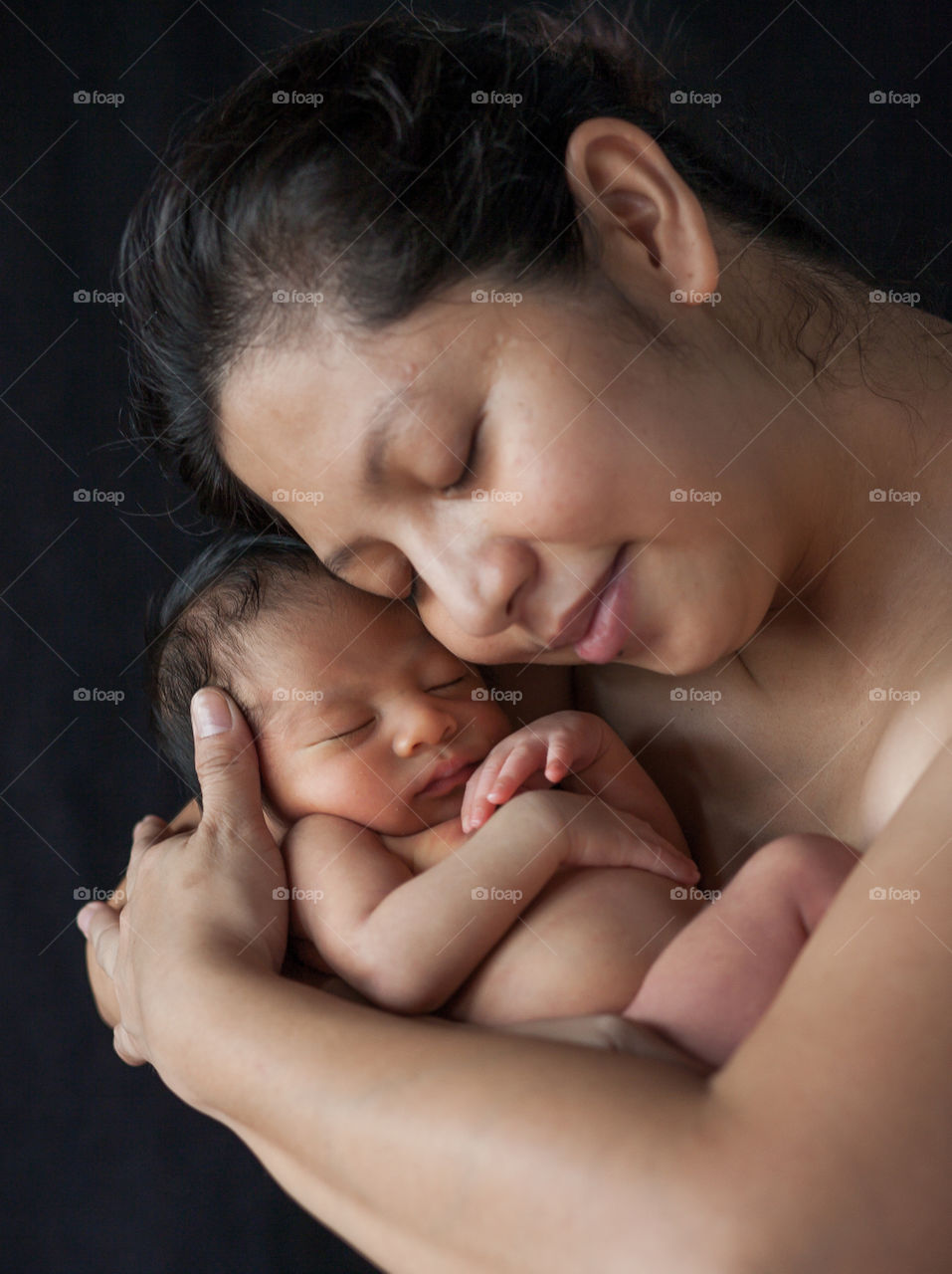 Mother hugging her sleeping baby