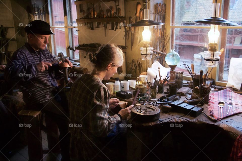 Husband and wife working in workshop